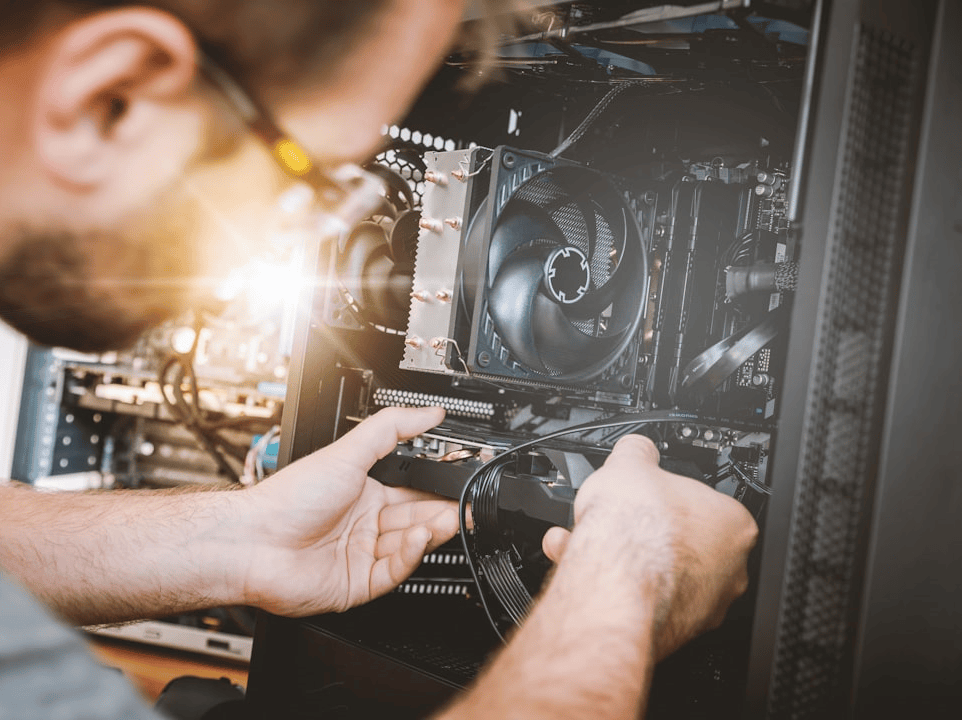 Tech Clinic technician working inside a desktop PC case